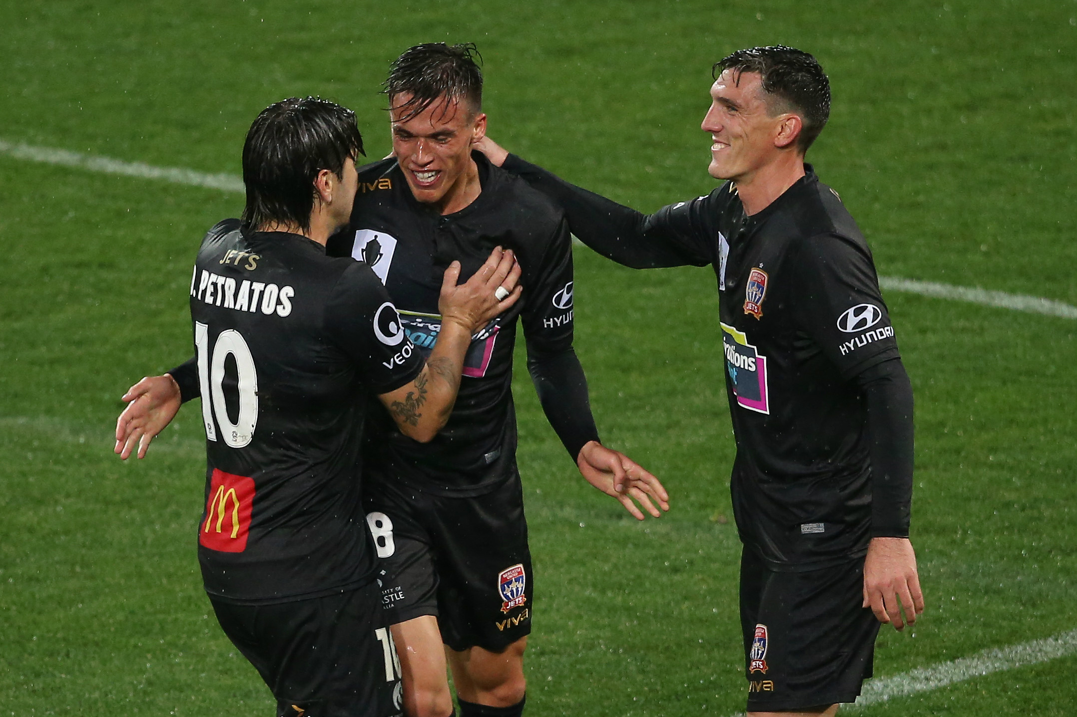 Dimitri Petratos and Matt Millar celebrate with Langlois after his match-winner against Victory