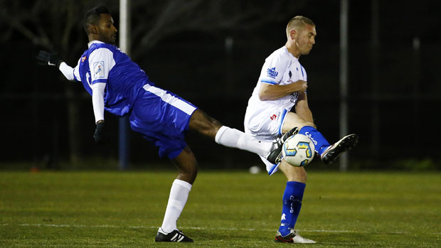 Lucas Lefevre and Bernard Rene fight for possession in the FFA Cup clash between Canberra Olympic and Surfers Paradise Apollo.
