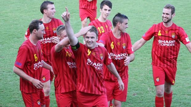 Peter Haynes celebrates with his Broadmeadow Magic teammates.