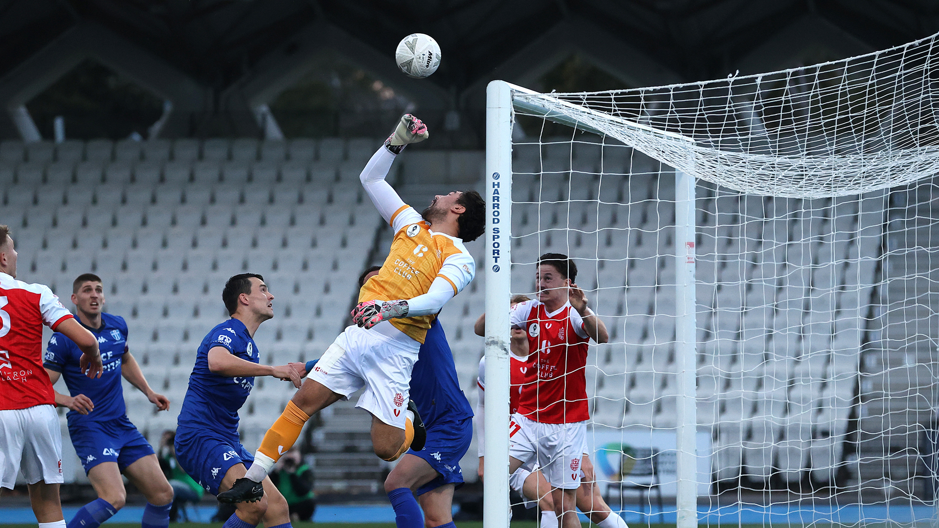 Matthew Lugo of Olympic FC punches the ball away in the penalty area