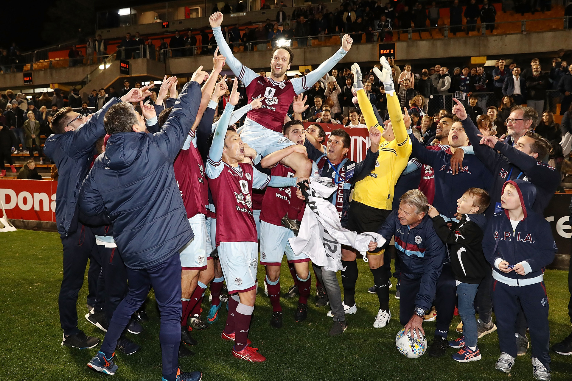 APIA Leichhardt Tigers players celebrate victory in the FFA Cup round of 16 match between APIA Leichhardt Tigers FC and Melbourne Victory at Leichhardt Oval on August 21, 2018