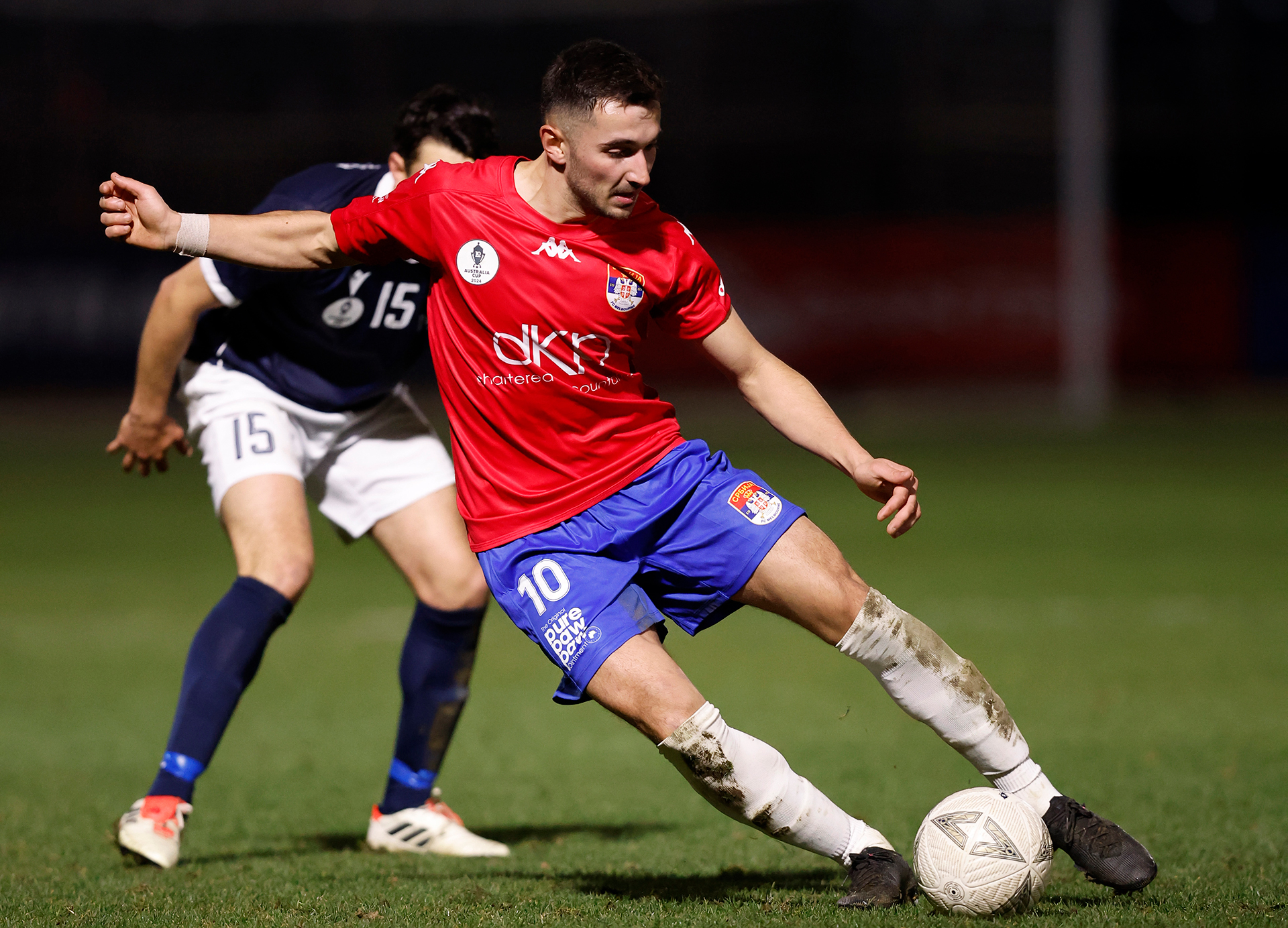 Marko Basic of Melbourne Srbija kicks the ball during the 2024 Australia Cup Round of 32 match between FC Melbourne Srbika and Modbury Jets SC at Home of the Matildas on August 06, 2024 