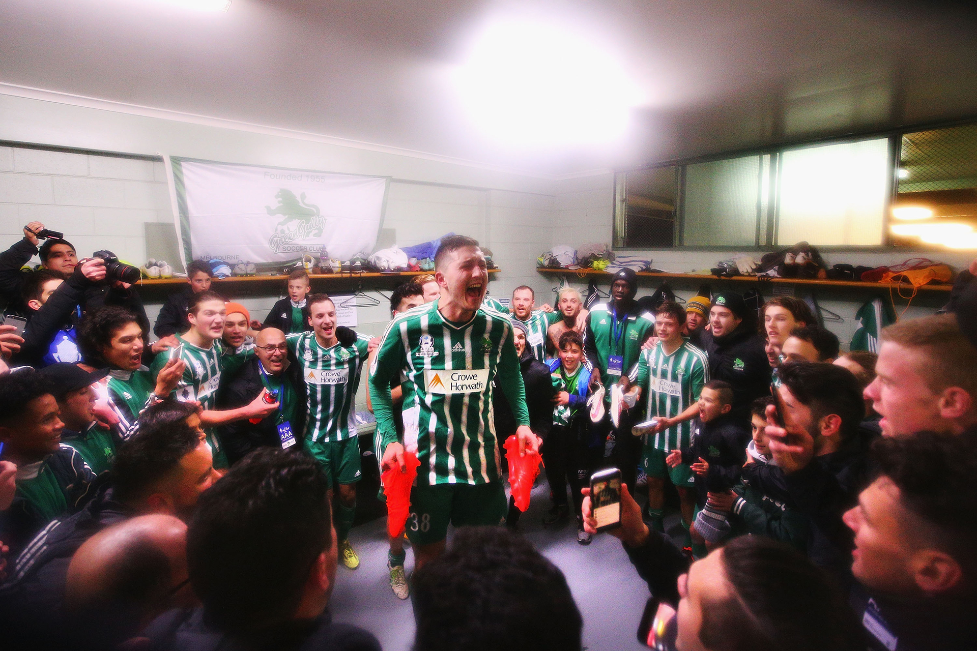 Liam Boland of Green Gully, teammates and fans celebrate the win during the Australia Cup Round of 32 match between Green Gully and the Central Coast Mariners at Green Gully Reserve on August 2, 2016