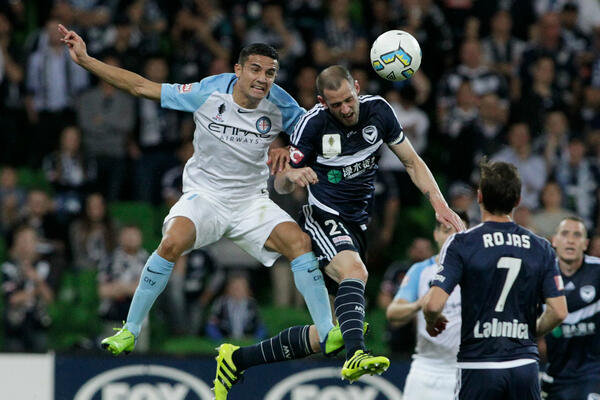 Tim Cahill and Carl Valeri compete for a header during the 2016 semi-final at AAMI Park.