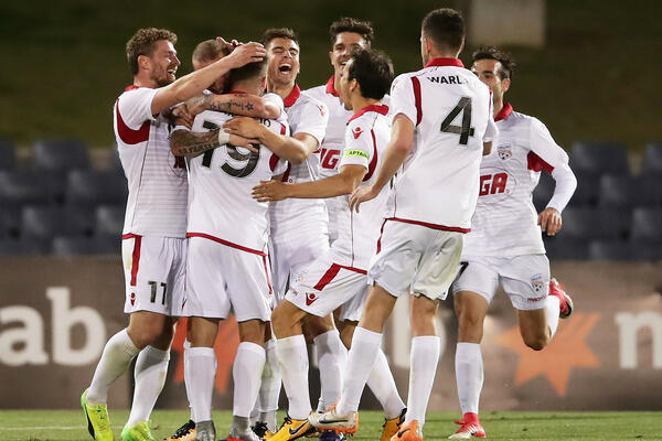 Adelaide United players celebrate a goal