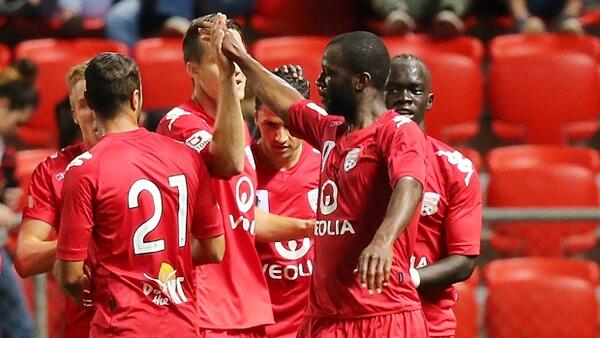 Bruce Djite celebrates with his team mates after scoring against Brisbane Roar.