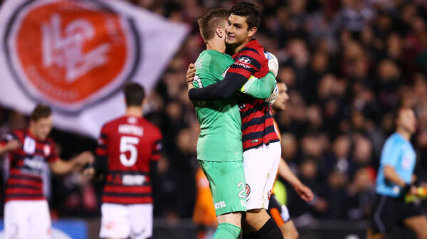 Wanderers goalkeeper Andrew Redmayne (L) celebrates with Daniel Alessi (R) after victory over Brisbane Roar.