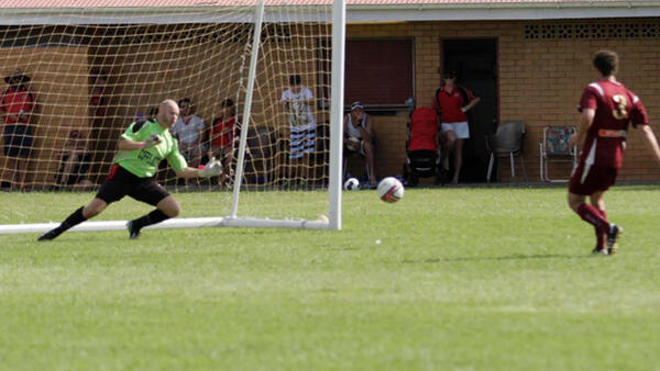 Coffs City United goal-keeper Ian Davie makes match-winning save.