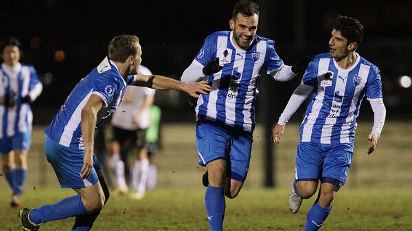Sydney Olympic FC players celebrate their late winner against Gungahlin United.