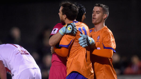 Lions FC players celebrate after the full-time whistle.