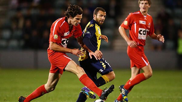 Wolves' Zachary MacKenzie shields the ball from Mariners goal scorer Glen Trifiro.