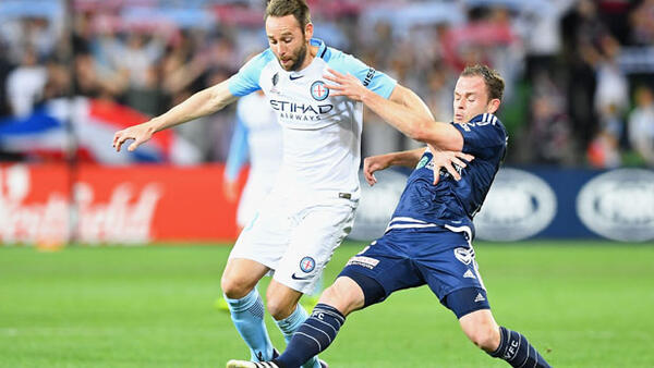 City defender Josh Rose fights for the ball with Victory midfielder Leigh Broxham.