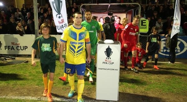 Striker captain Greg King leads his side out against Broadmeadow Magic on opening night.