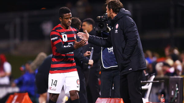 Golgol Mebrahtu of the Wanderers shakes hands with Wanderers coach Tony Popovic after being replaced in the second half.