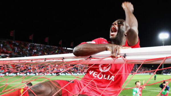 Bruce Djite celebrates Adelaide United's Westfield FFA Cup triumph.