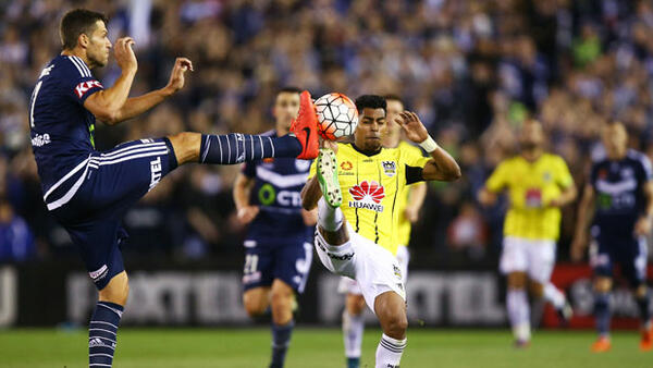 Victory's Matthieu Delpierre gets his leg up high to try and dispossess Roy Krishna.