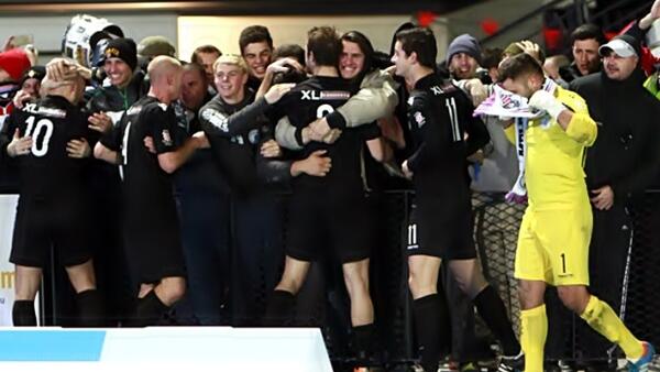 Melbourne Knights players celebrate with their fans after the final whistle.