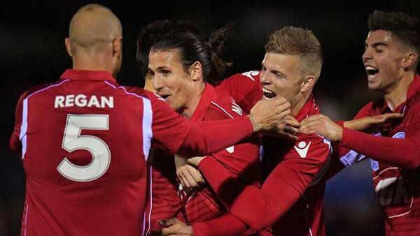 Adelaide United players celebrate Michael Marrone's winning goal against Newcastle Jets.
