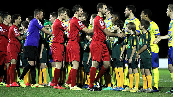 Broadmeadow Magic and Brisbane Strikers shake hands before kick-off in their Westfield FFA Cup tie.