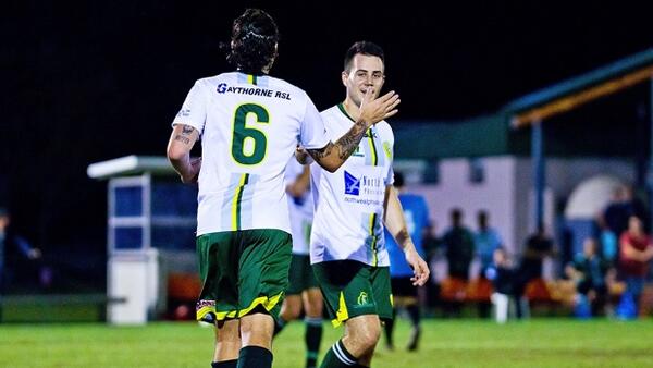 Steven Chester celebrates his hat trick with team mate and goal provider Scott Dykman.