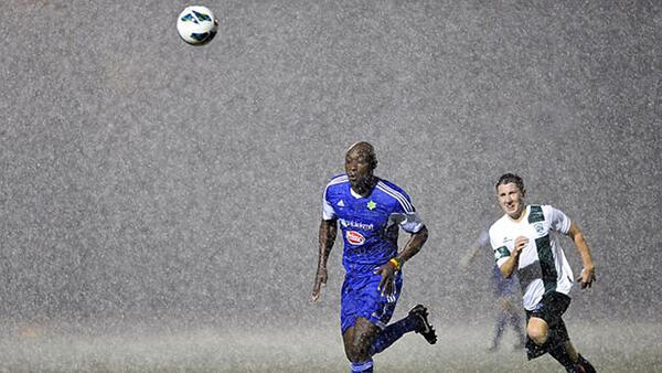 Lloyd Owusu chases down a ball in torrential rain at Hensley Athletic Field.