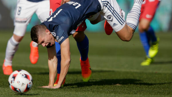 Mitch Austin picks up an injury in Melbourne Victory's win against Atletico Madrid.