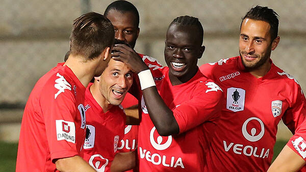 Adelaide United celebrate Sergio Cirio's goal against Brisbane Roar.