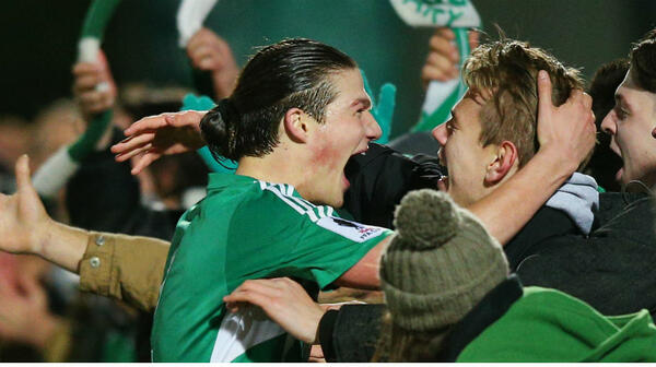 Green Gully's Mathew Reid celebrates his side's win over the Mariners with Gully fans.