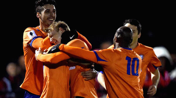 Lions FC celebrate scoring the opener against Croydon Kings.