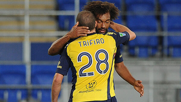 Isaka Cernak of the Mariners celebrates scoring a goal with Glen Trifiro.