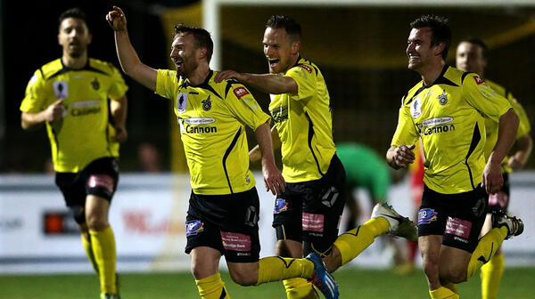 Jack Petrie of Heidelberg celebrates with team mates after scoring against Broadmeadow Magic.