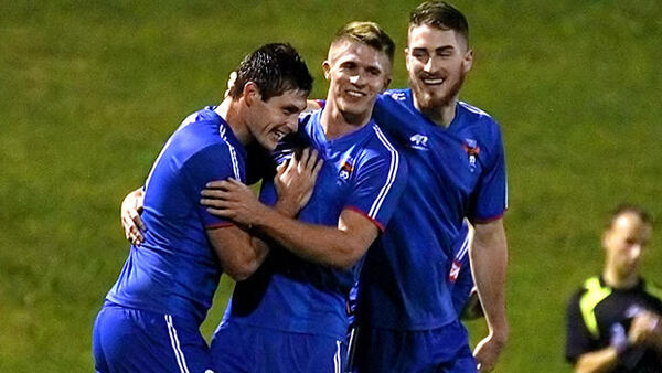 Former A-League player Chris Payne celebates with his Manly United teammates.