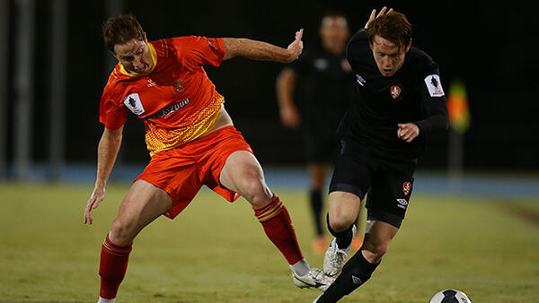 Hayden Doyle of the Lions challenges Corey Brown of the Roar.