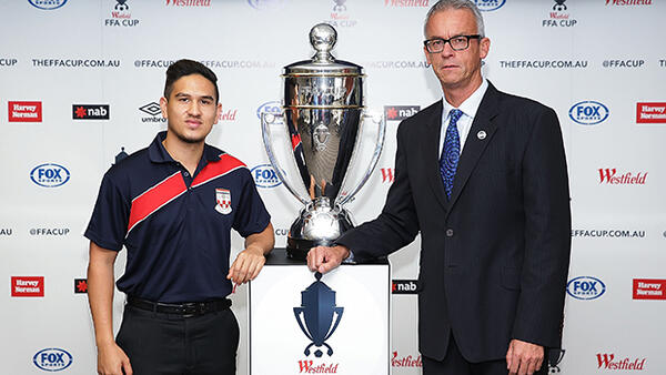 Sydney United's Kaz Patafta poses with the FFA Cup trophy alongside FFA CEO David Gallop.