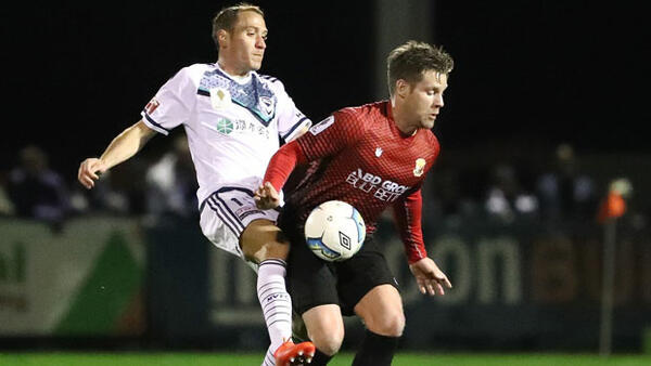 Victory defender Alan Baro fights for the ball with Hume's Tom Cahill.