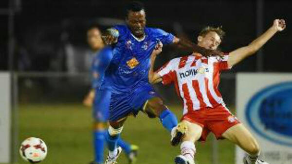 University Azzurri’s Isaac Abakah (left) tangles with Darwin Olympic’s Alexander Turner in the FFA Cup replay.