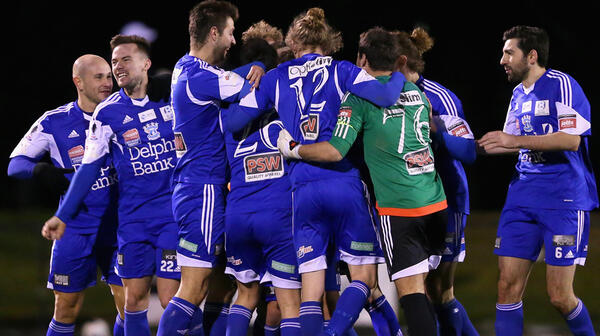 Dean Piemonte of the Cannons is congratulated by team mates after scoring against the FNQ Heat.
