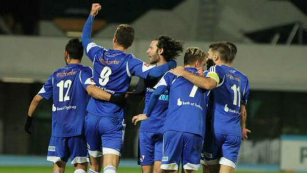 South Melbourne players celebrate scoring against the Melbourne Knights.