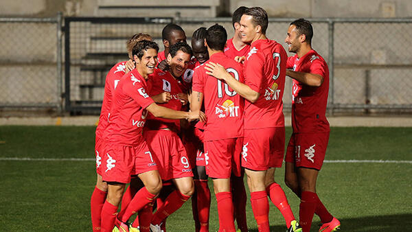 Adelaide United celebrate a goal in their 2-0 win over Brisbane Roar.